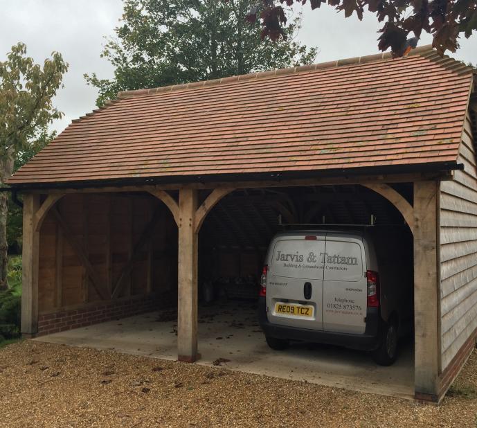 Carport with oak frame and tiled roofing.